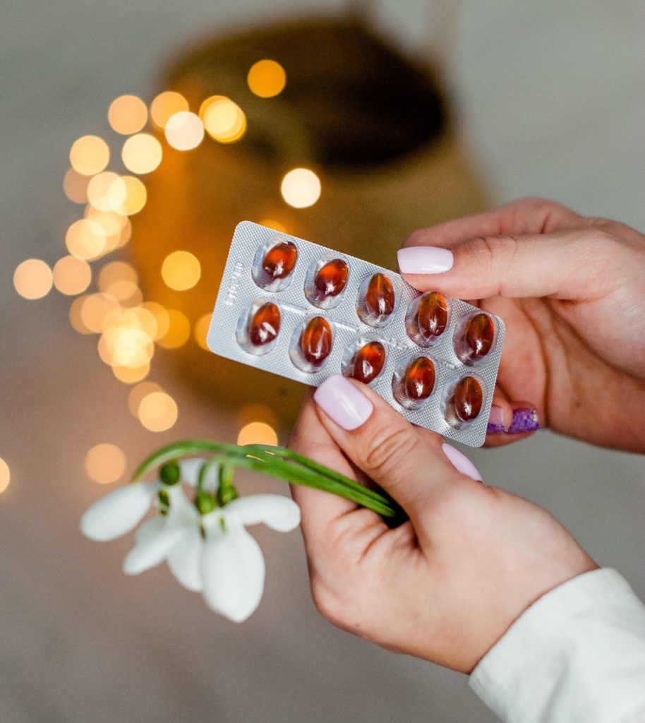 family member holding flowers and cancer-causing medication