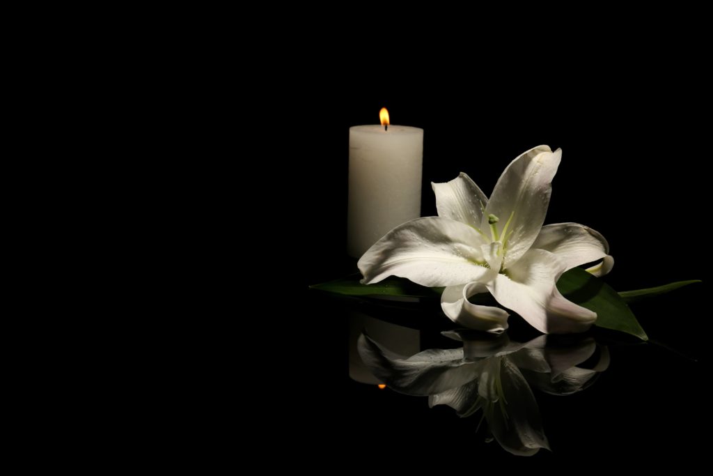 flower and candle left to mourn a wrongful death