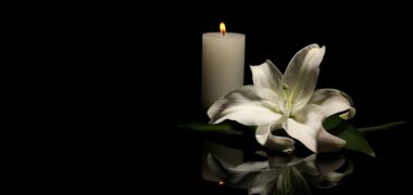 flower and candle left to mourn a wrongful death